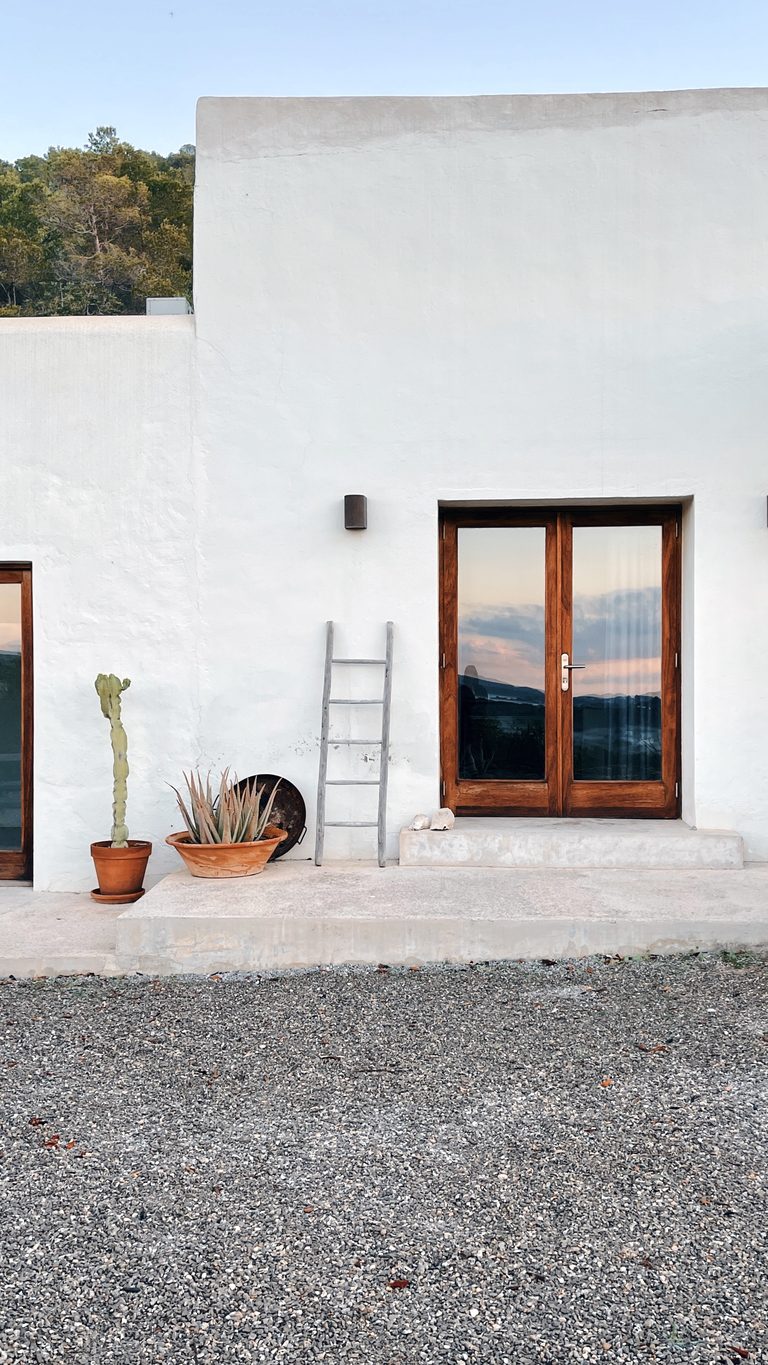 Guest at a 1:1 somatic retreat in Ibiza, sitting outside with a view over the hills